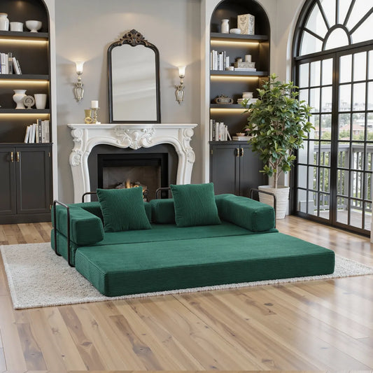 Green corduroy sofa bed unfolded into bed with black frame