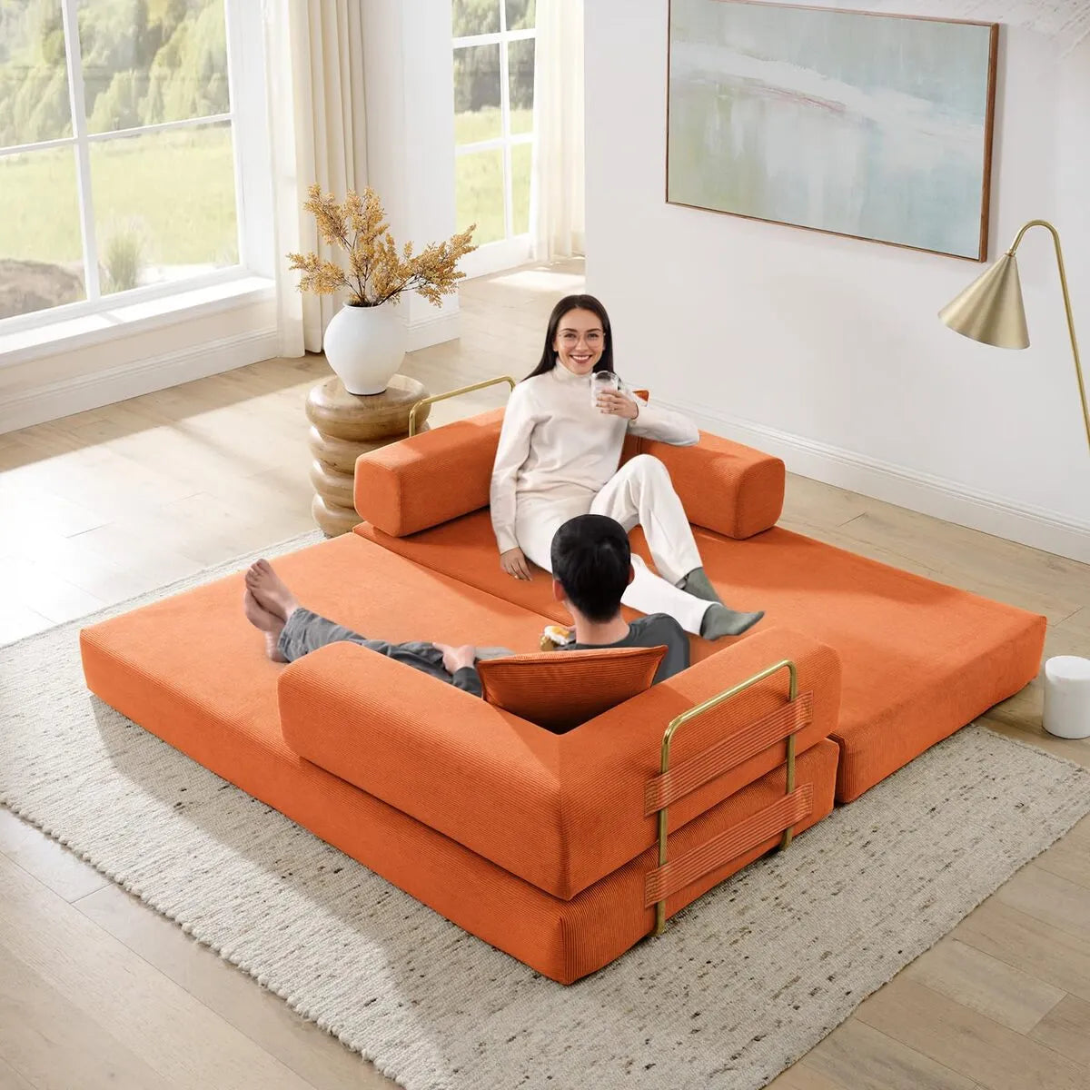 Orange convertible sofa mattress laid flat as floor bed